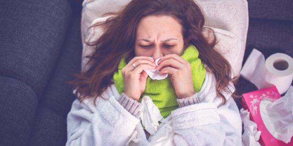 Woman suffering from influenza sleeping in bed